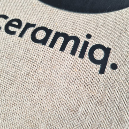 Beige protective apron with logo